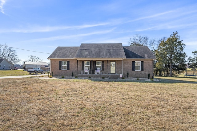 single story home with covered porch and a front yard