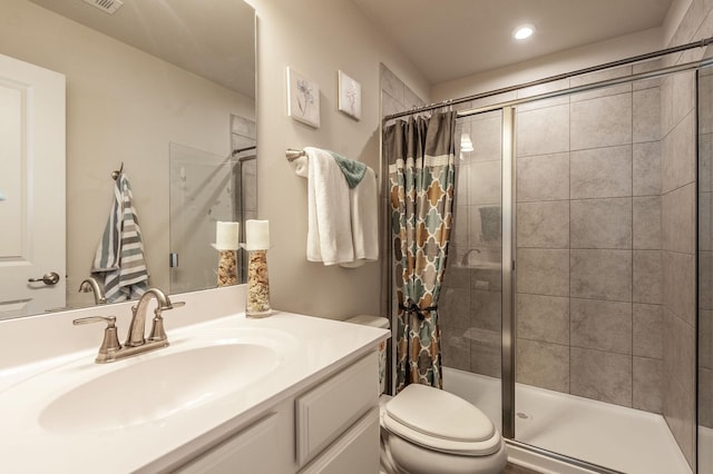 bathroom featuring vanity, curtained shower, and toilet