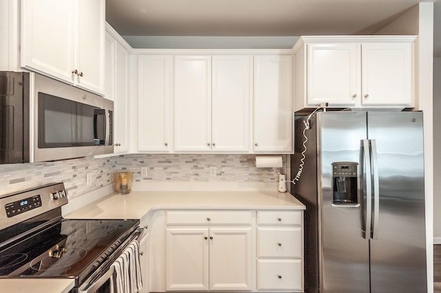 kitchen featuring backsplash, appliances with stainless steel finishes, and white cabinets