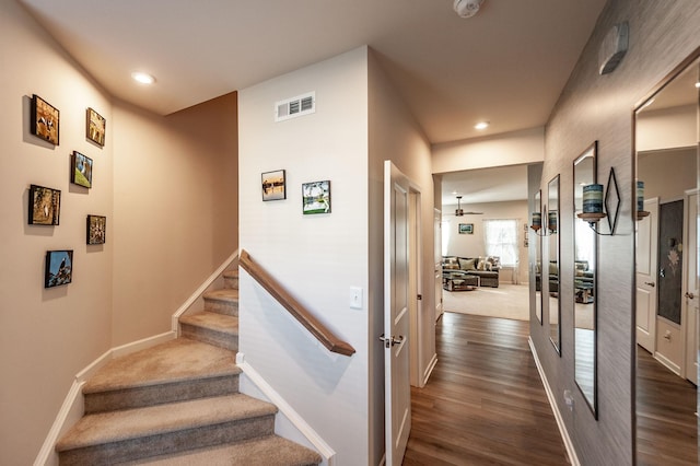 stairs featuring hardwood / wood-style flooring