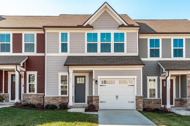 view of front of property featuring a garage and a front lawn