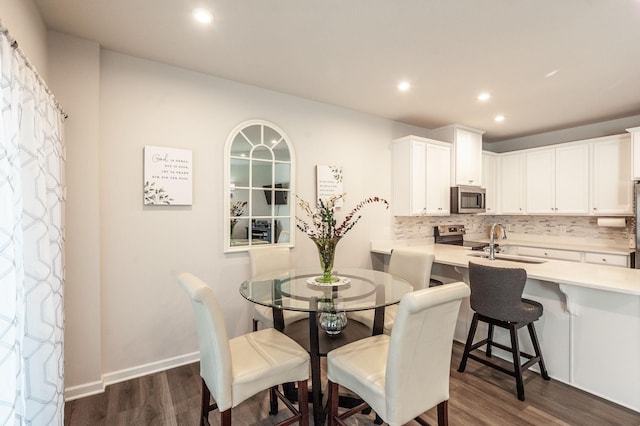 dining room featuring dark wood-type flooring and sink