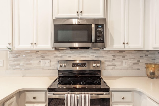 kitchen featuring white cabinetry, decorative backsplash, and appliances with stainless steel finishes