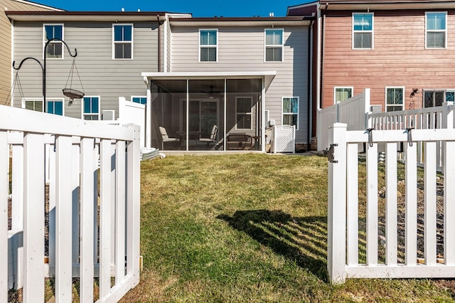 back of property featuring a lawn and a sunroom