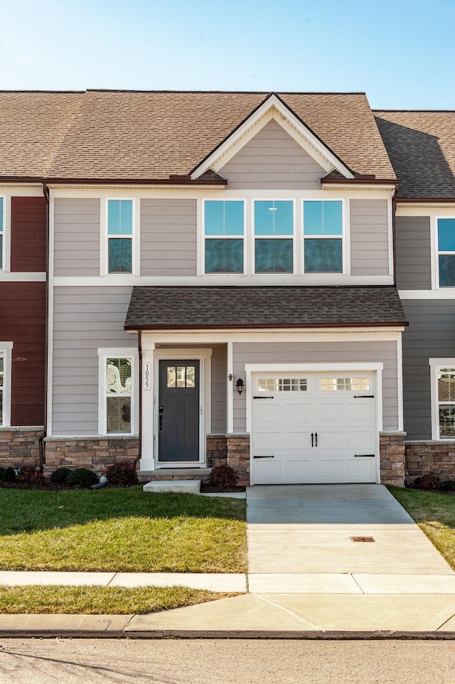 craftsman-style home featuring a garage and a front yard