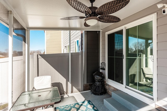 sunroom featuring ceiling fan