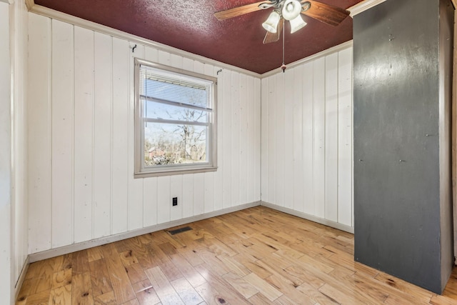 unfurnished room featuring ceiling fan, baseboards, and hardwood / wood-style floors