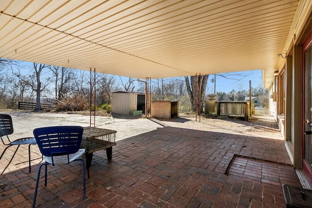 view of patio featuring a shed and an outdoor structure