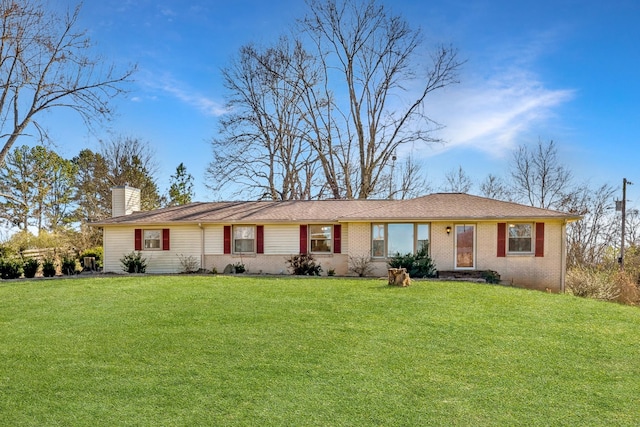 single story home with a chimney, a front lawn, and brick siding