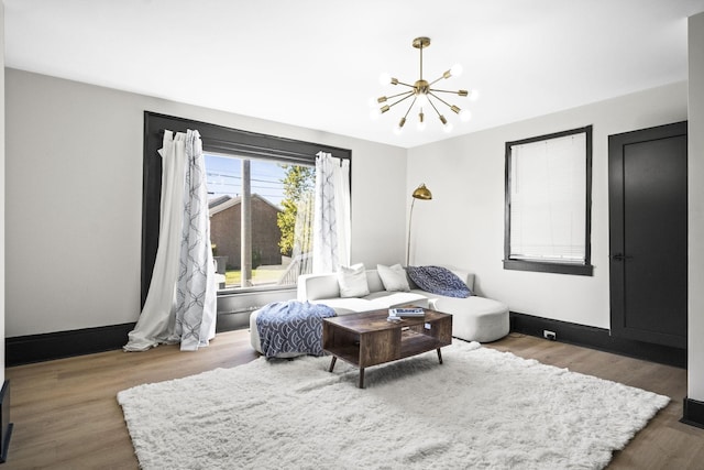 living room featuring dark wood-type flooring and a notable chandelier