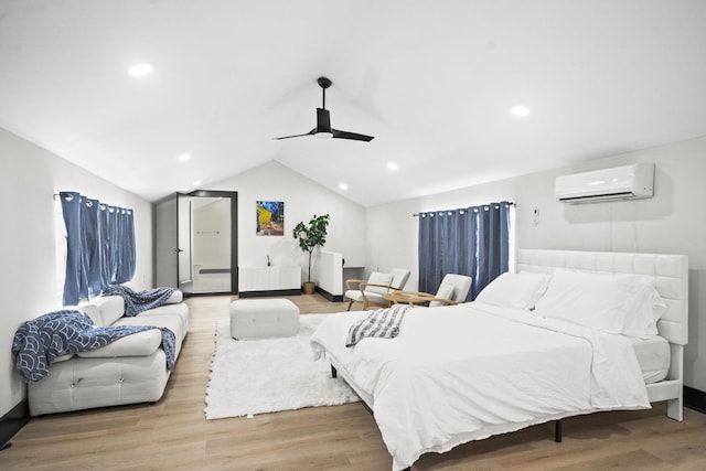 bedroom featuring lofted ceiling, a wall mounted air conditioner, ceiling fan, and light wood-type flooring