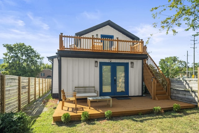 back of house with a wooden deck and french doors