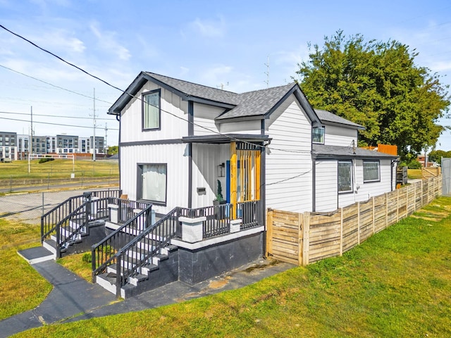 rear view of property featuring a yard