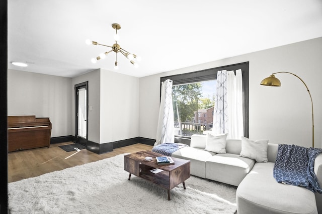 living room featuring hardwood / wood-style floors and a notable chandelier