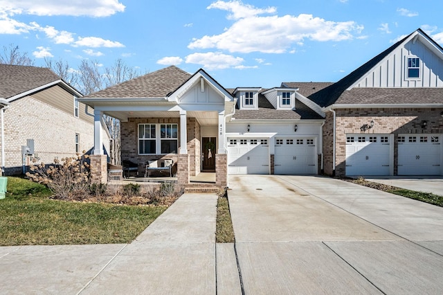 view of front of property featuring a garage, covered porch, and a front lawn