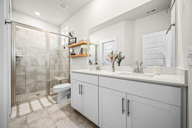 bathroom featuring vanity, a shower with shower door, and toilet