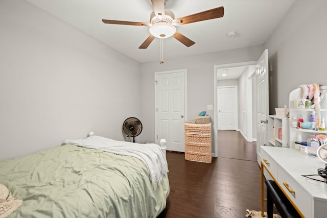 bedroom with dark hardwood / wood-style floors and ceiling fan