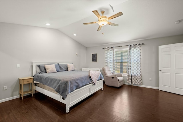 bedroom featuring dark wood-type flooring, vaulted ceiling, and ceiling fan