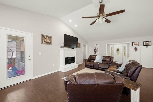 living room featuring ceiling fan, lofted ceiling, and dark hardwood / wood-style flooring