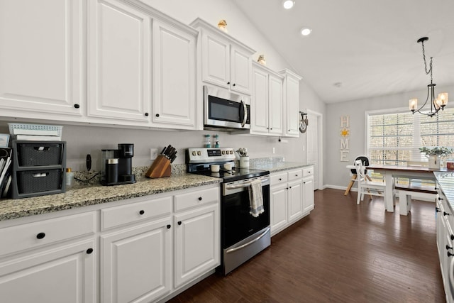 kitchen featuring white cabinetry, vaulted ceiling, appliances with stainless steel finishes, dark hardwood / wood-style floors, and pendant lighting