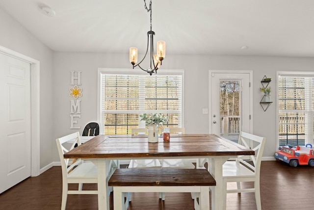 dining area featuring dark hardwood / wood-style flooring and a notable chandelier