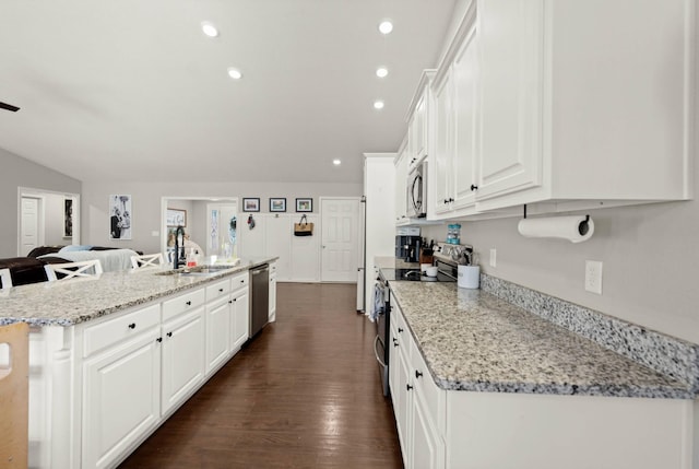 kitchen featuring white cabinetry, appliances with stainless steel finishes, sink, and light stone counters