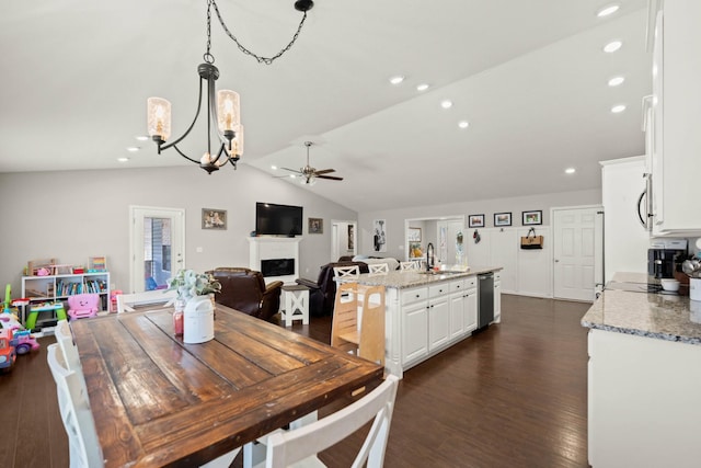 dining space featuring vaulted ceiling, sink, ceiling fan, and dark hardwood / wood-style flooring