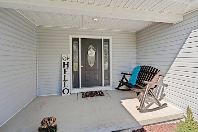 view of exterior entry with a porch