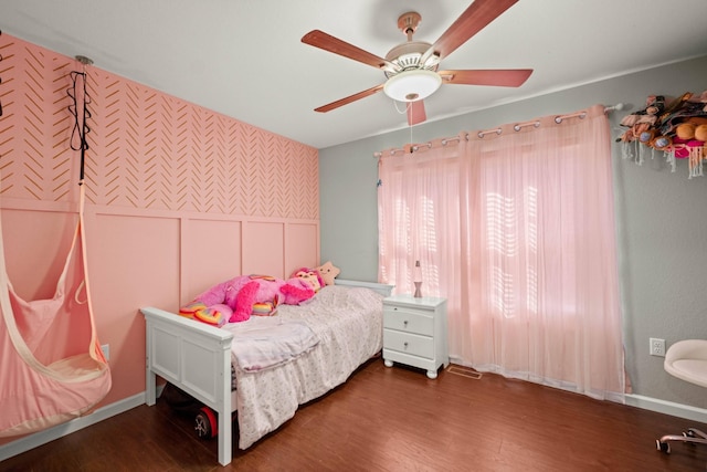 bedroom with dark hardwood / wood-style floors and ceiling fan