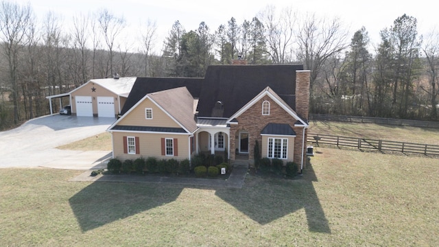 view of front of home featuring a garage, a front lawn, and a carport