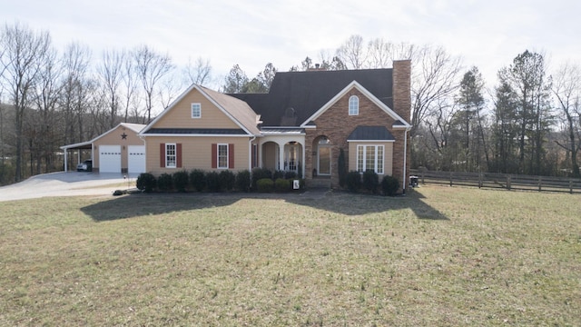 traditional-style home featuring a chimney, fence, and a front yard