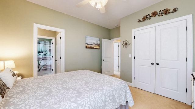 bedroom featuring a ceiling fan, a closet, and light carpet