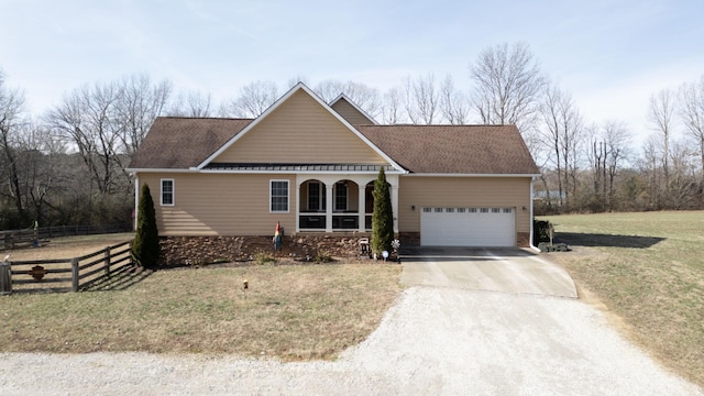 view of front of home with a garage, a shingled roof, fence, driveway, and a front lawn