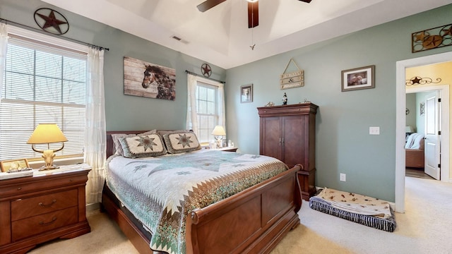 bedroom with light colored carpet, visible vents, ceiling fan, and baseboards