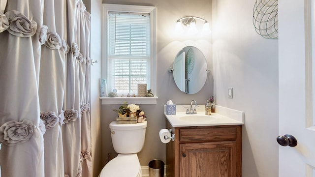 full bath featuring vanity and toilet
