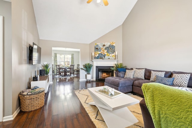 living room featuring dark wood-type flooring, ceiling fan, and high vaulted ceiling