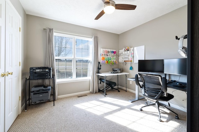 office with light carpet and ceiling fan