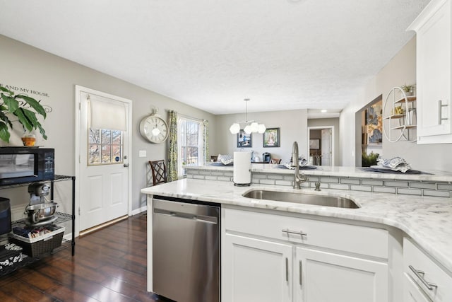 kitchen featuring sink, dark wood-type flooring, dishwasher, white cabinetry, and hanging light fixtures