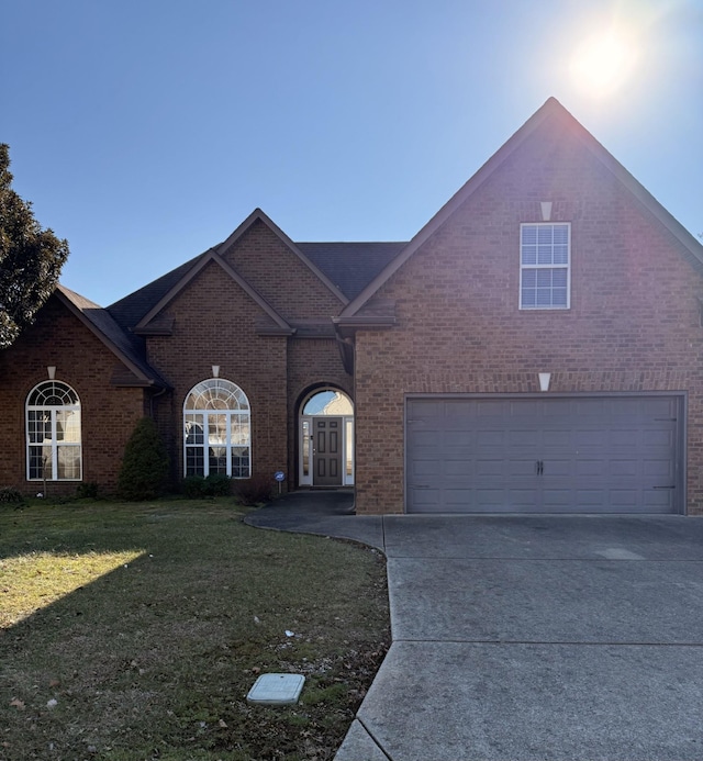 view of front of home with a garage and a front lawn