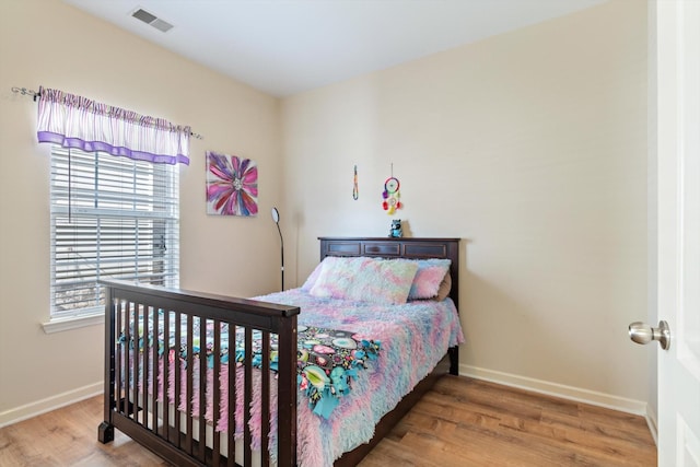 bedroom with hardwood / wood-style flooring