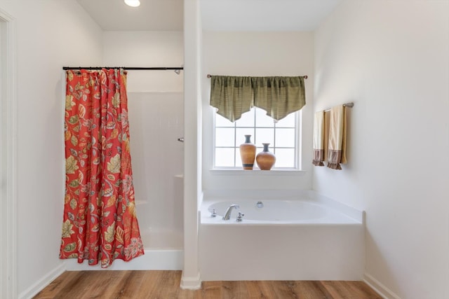 bathroom with wood-type flooring and separate shower and tub