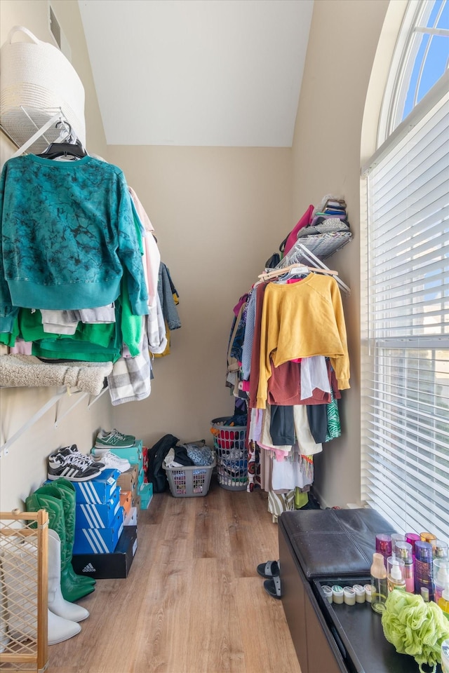 spacious closet featuring hardwood / wood-style flooring and lofted ceiling