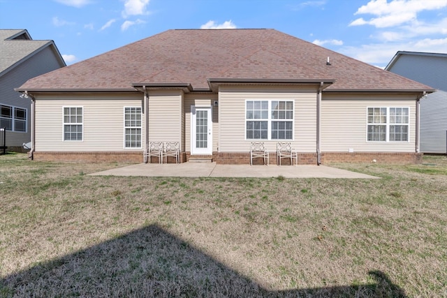 back of house with a lawn and a patio