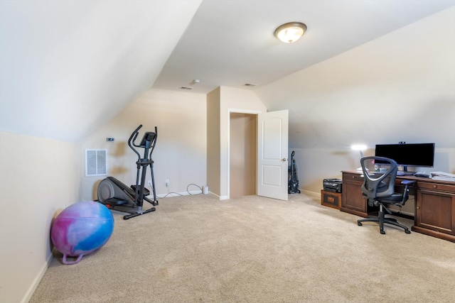 carpeted office space with vaulted ceiling