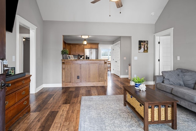 living room with ceiling fan, dark hardwood / wood-style floors, and vaulted ceiling