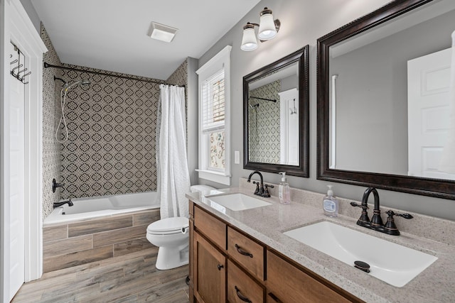 full bathroom featuring vanity, wood-type flooring, shower / bath combo, and toilet