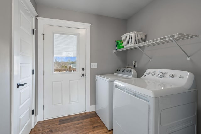 laundry room featuring dark wood-type flooring and washer and dryer