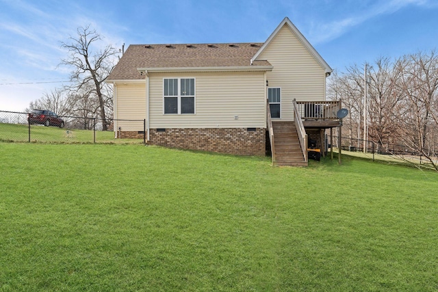 rear view of house featuring a yard and a deck