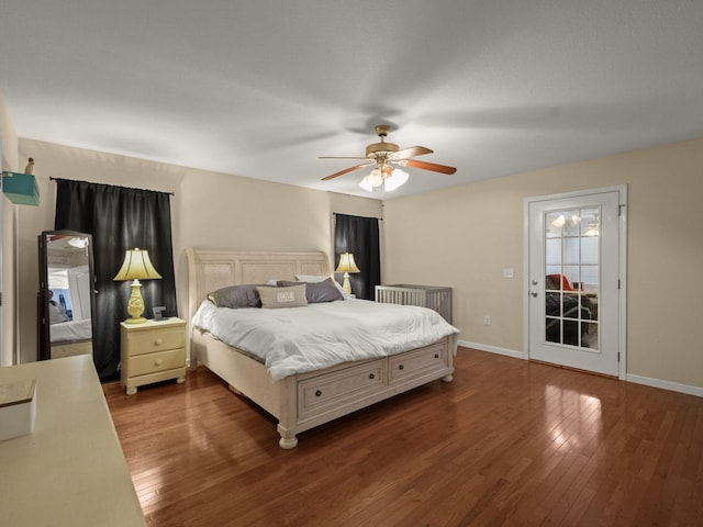 bedroom featuring ceiling fan, dark hardwood / wood-style floors, and access to outside