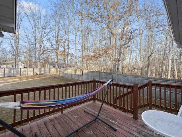 wooden terrace featuring a lawn